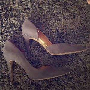 Gray high heels with gold trim.